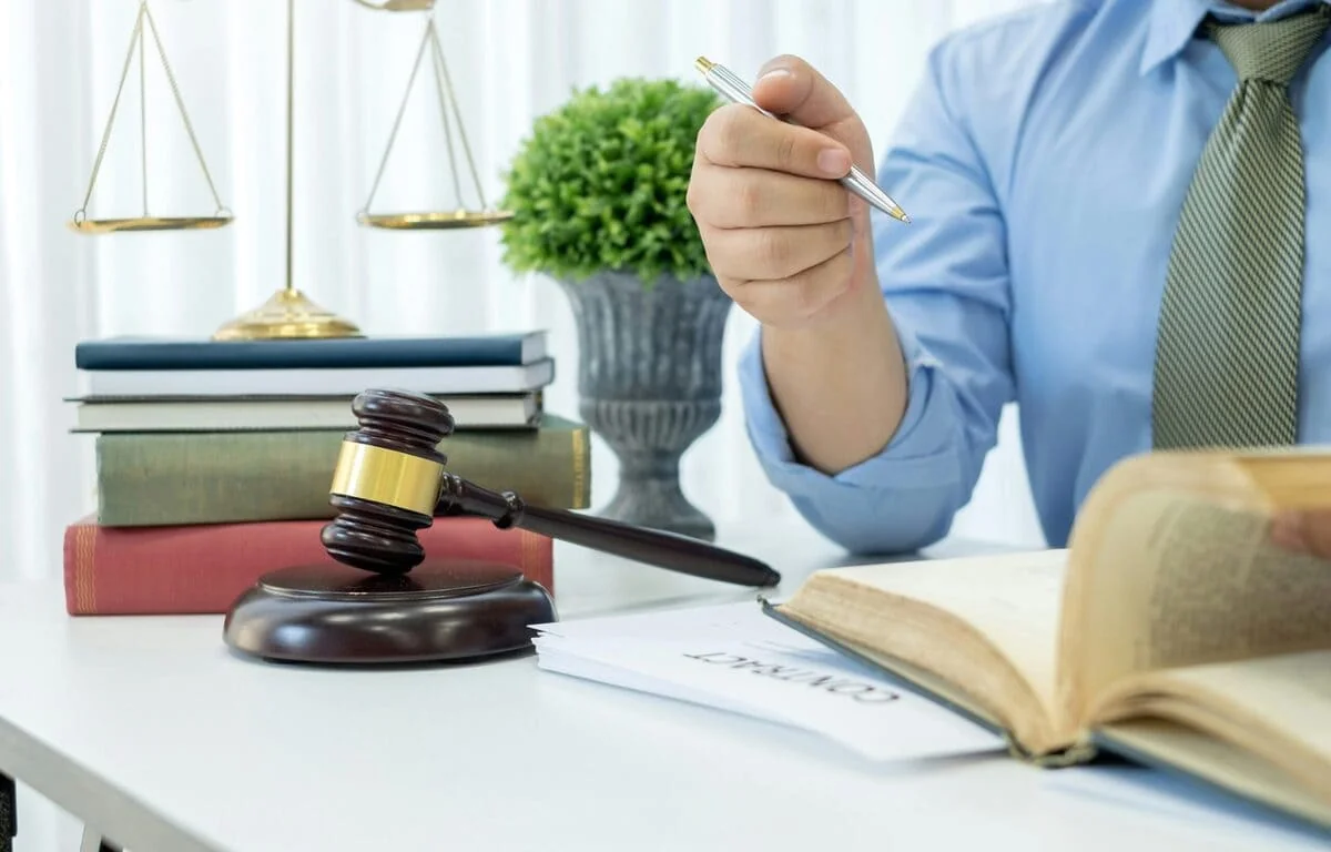 Employment Termination Legal Review Lawyer reviewing termination contract with gavel and legal books