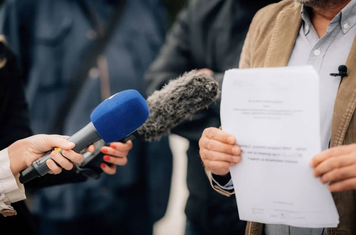 Whistleblower Rights and Anti-Retaliation Laws Press interview with person holding a whistleblower report
