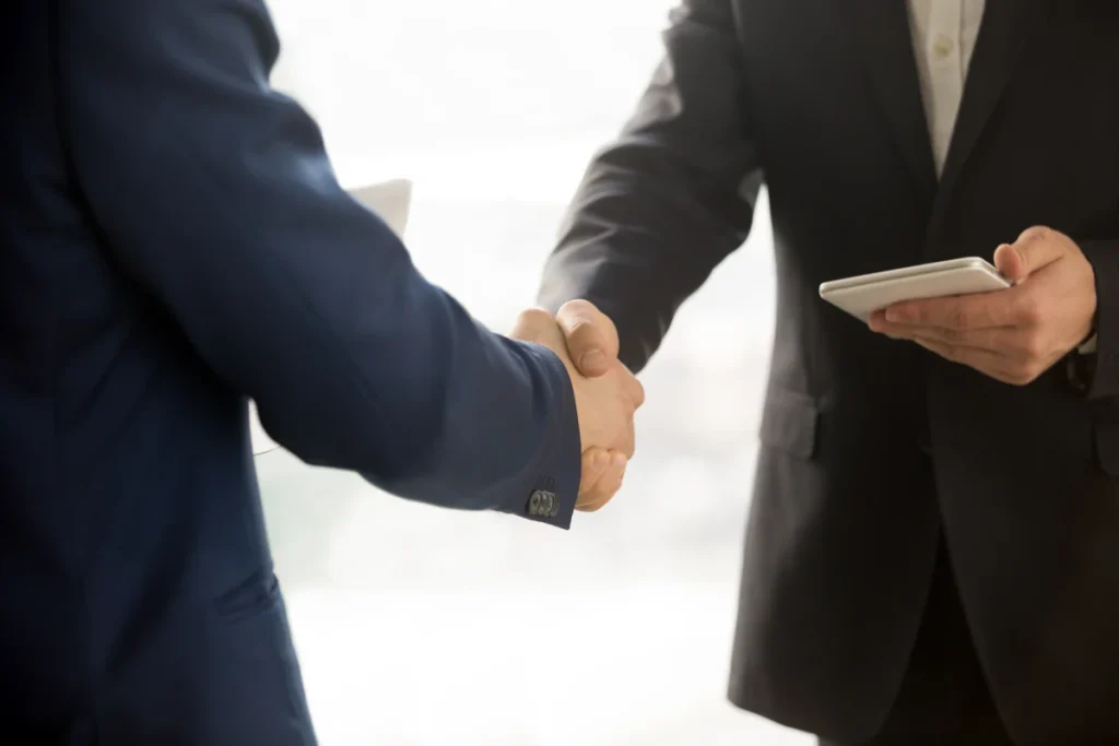 two business partners shaking hands about Free Time Tracking Software