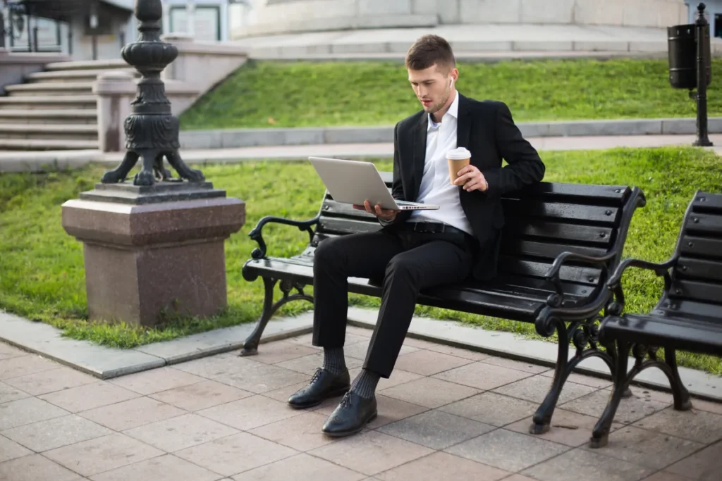 hardworking male employee on meeting at the park tracking work with Employee Time Clock Software