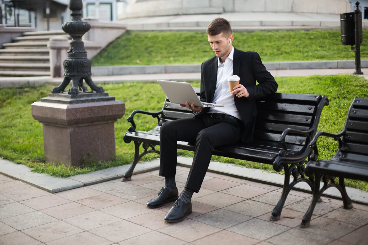 hardworking male employee on meeting at the park tracking work with Employee Time Clock Software