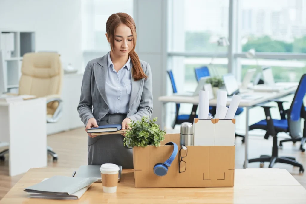 female employee packing office supplies for leave after not constantly using Employee Time Tracking Software