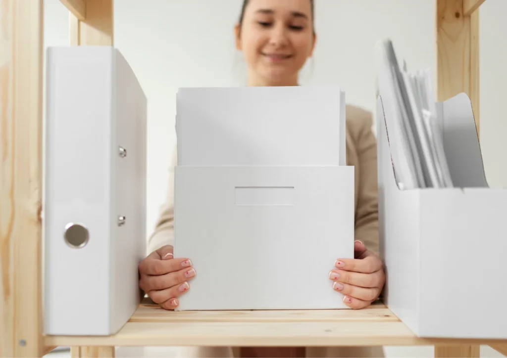 employee organizing Time Sheet Tracker paper in folders