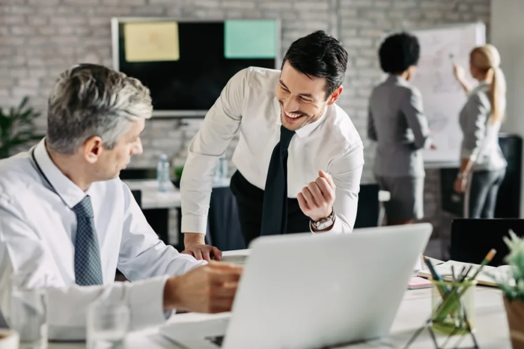 male worker who uses Time Tracking Software for Employees cheering on for other office employee