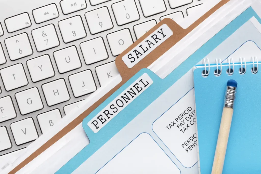 Employee payroll documents and time tracking records organized for accurate payroll processing