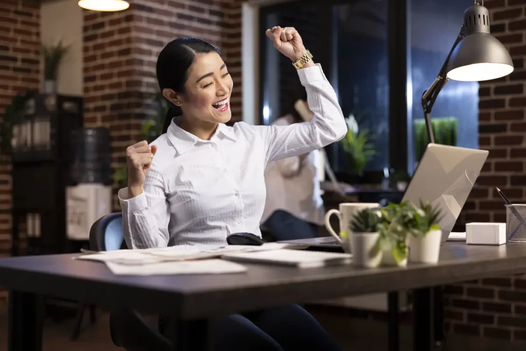 Business owner celebrating a smooth workday after using reliable desktop time clock software