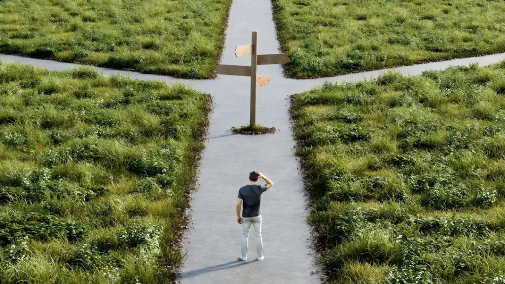 Business owner standing at a crossroads deciding between timesheets and time clock software