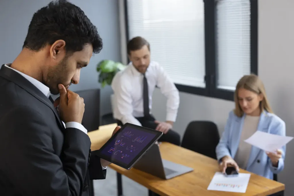 business manager reviewing employee work hours and payroll summary report on laptop after calculating totals