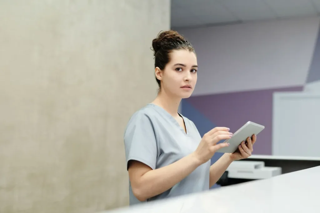 Front desk employee recording her work hours on a tablet